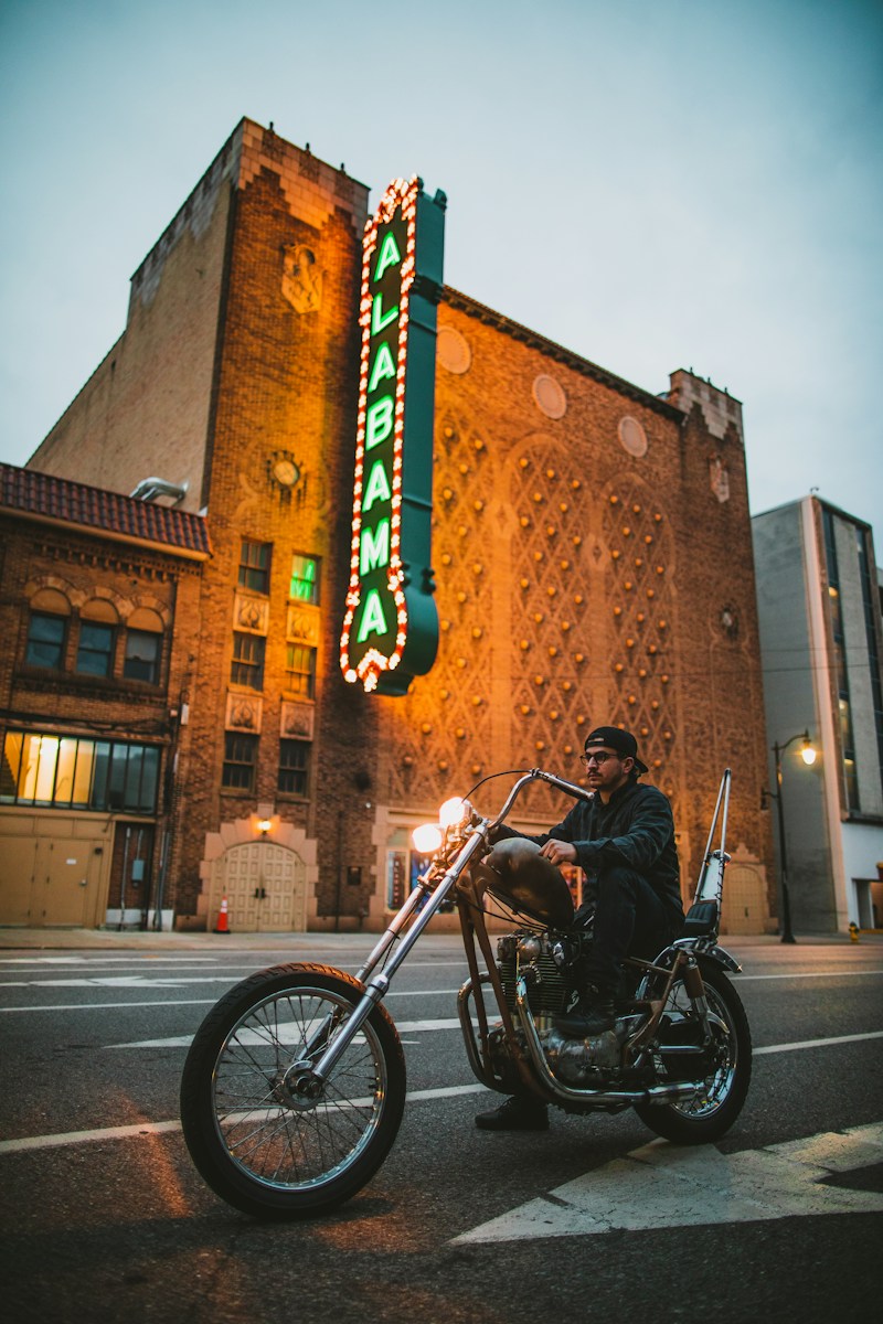Alabama Theater in Birmingham with a guy on a motorcycle – Representing Insurance 101, where we simplify insurance coverage.