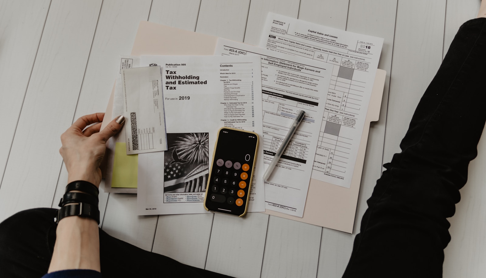 Business owner reviewing insurance documents and tax paperwork at a desk